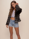 Woman wearing Black Tundra Fox Faux Fur Bomber Jacket, front view