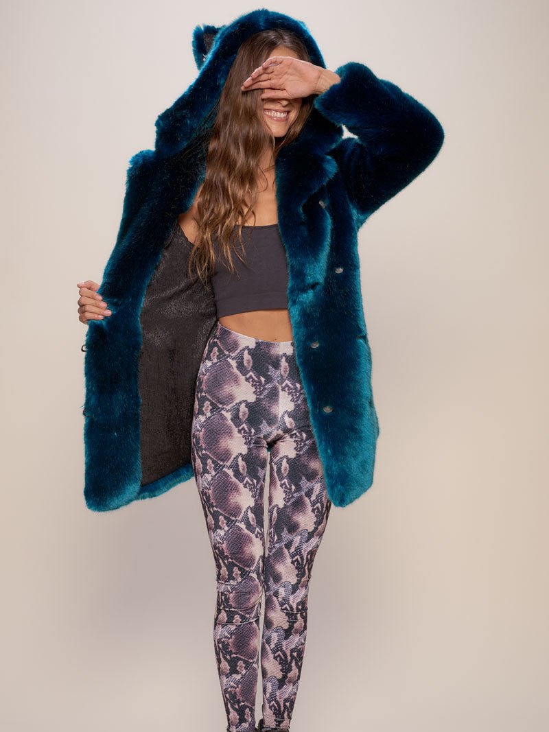 Smiling girl with her hand over her eyes, holding one side of the Royal Wolf Classic Luxe faux fur coat to show the liner.