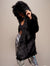 Woman model twisted to one side wearing realist black wolf coat with hood and ears on.