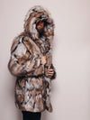 Bearded man with the hood of the Hooded Wolverine fur coat covering half his face, turned to the side, holding the coat closed.