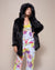 Woman Wearing Black Wolf Hooded Faux Fur Coat Over Her Pajamas