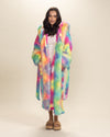 Cozy dark-haired girl in nearly closed Rainbow Bear Vegan Fur Robe, hands in pockets, untied belt, with a relaxed 'just woke up' vibe.