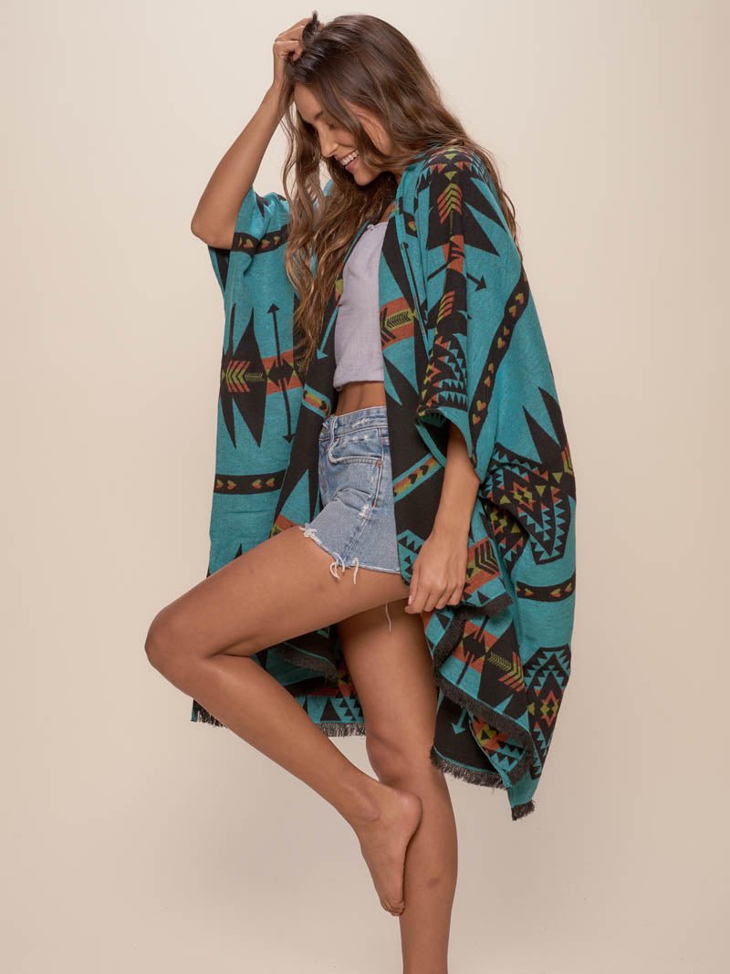 Woman wearing Grey Wolf Fabric Poncho, side view