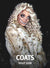 Woman with blonde hair wearing a snow leopard faux fur coat and skeleton face make up