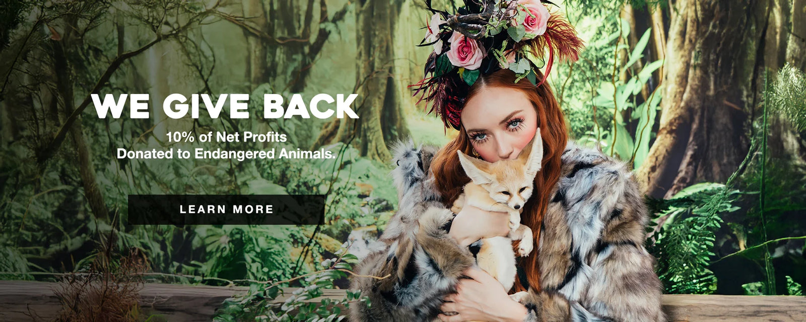 Red head girl holding a fennel fox and wearing a wolverine faux fur coat 