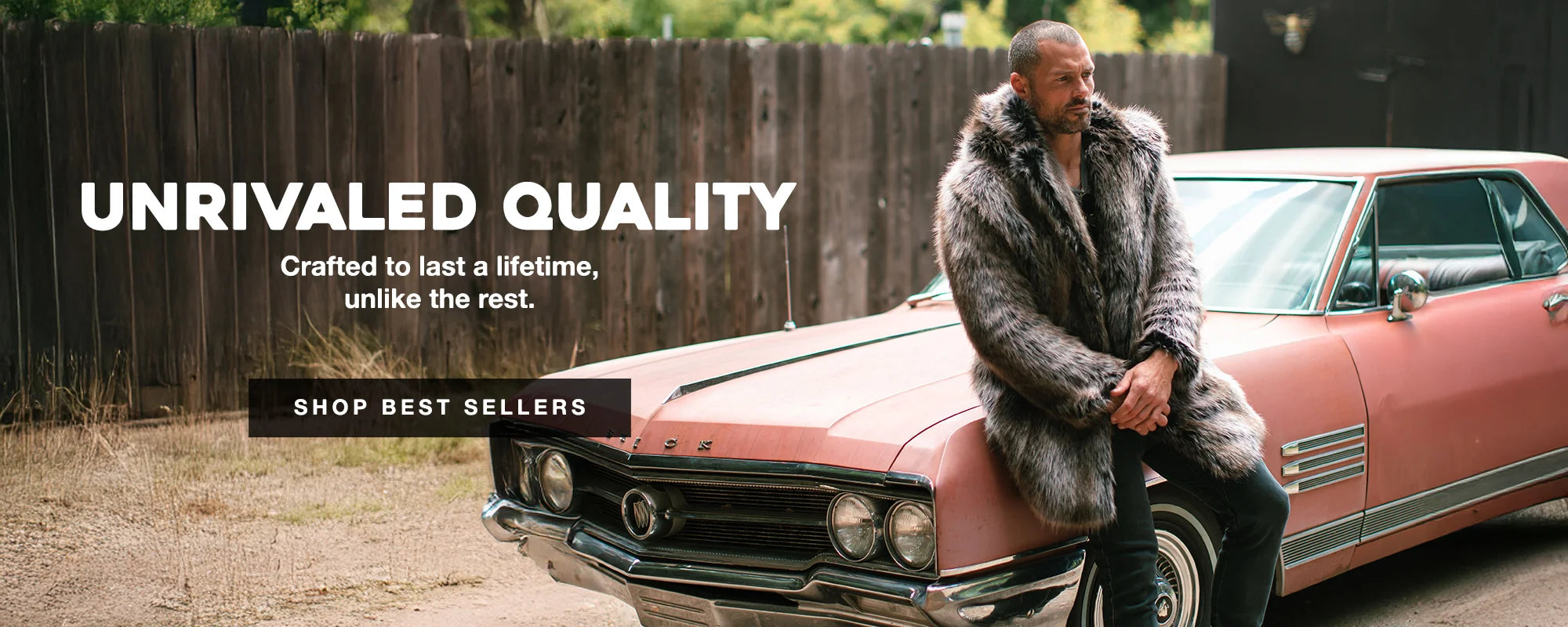 MAN LEANING AGAINST A PINK CAR WEARING A GREY WOLF FAUX FUR COAT