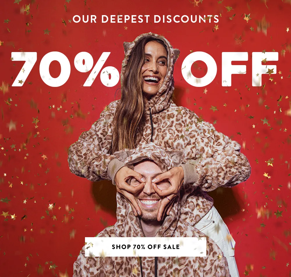 Red backdrop with a woman and man wearing a tan leopard hoodie 70% Off Sale 