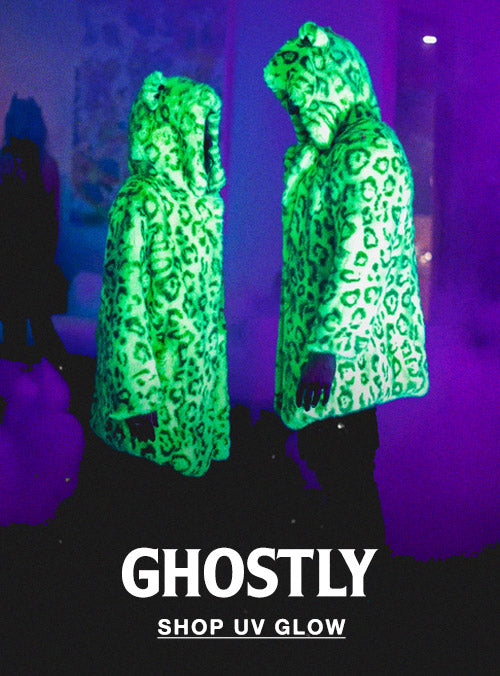 two people looking at each other wearing neon green leopard faux fur coats with uv blacklight