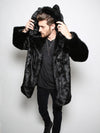 Male model facing slightly to the side with hands raised holding hood and ears of black panther faux fur jacket.