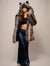 Woman wearing Grey Wolf Classic Faux Fur Coat in long floor length indigo sequin skirt